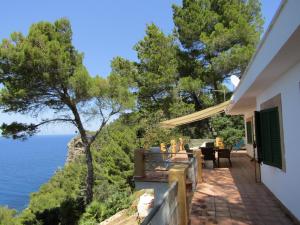 a house with a balcony with a view of the ocean at Son Riera Petit Paradís in Banyalbufar
