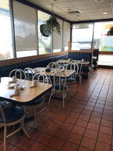 a row of tables and chairs in a restaurant at Days Inn by Wyndham Bradenton - Near the Gulf in Bradenton