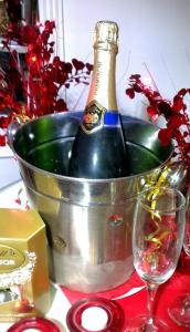 a bottle of champagne in a bucket on a table at The Bath House Boutique B&B - IN-ROOM Breakfast - FREE parking in Bath