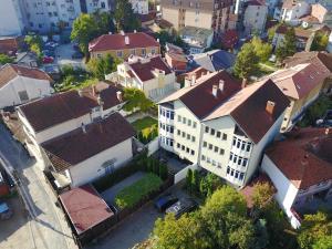 an overhead view of a large white building with red roofs at Cima Apartment in Pristina