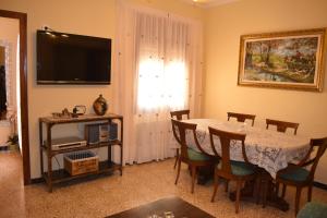 a dining room with a table and a television at Cal Cap Blanc in Masllorens