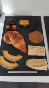 a tray with different types of food on a table at Villa BORA BORA in Gujan-Mestras