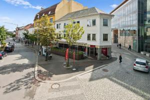 a city street with cars parked on the street at Frogner House - Fiskepiren in Stavanger