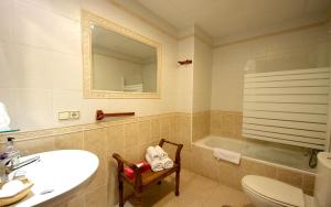 
a bathroom with a toilet a sink and a bath tub at Hotel Boutique Alicia Carolina in Monachil
