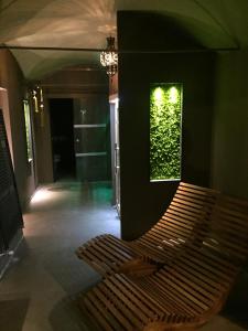 una panchina in una stanza con una parete verde di La Rocca Guest House & Spa a Montefalco