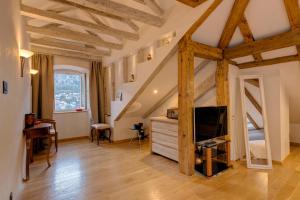 a living room with wooden ceilings and a tv at Kotor old town Palace Bucha in Kotor