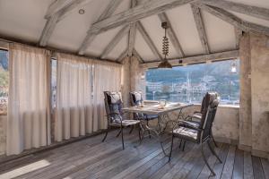 a dining room with a table and chairs at Kotor old town Palace Bucha in Kotor +42 photos