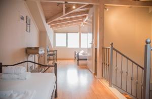 a bedroom with a bed and a staircase in a room at Aperanto House Paralia Loutsas in Loutsa