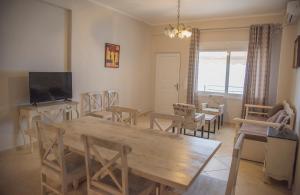 a dining room with a wooden table and chairs at Aperanto House Paralia Loutsas in Loutsa