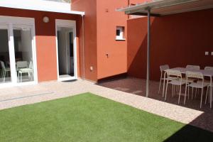 a patio with a green floor in front of a building at Lisboa Comfort Apartment in Lisbon
