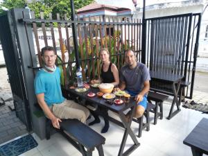 a group of three people sitting at a table at Titan's Greenhouse in Banyuwangi