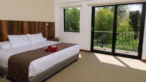 מיטה או מיטות בחדר ב-Hotel Villa del Carmen