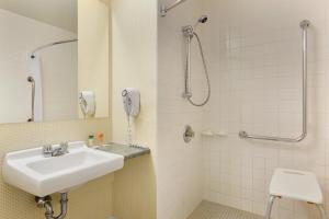 a bathroom with a sink and a shower at Travelodge by Wyndham North Bay Lakeshore in North Bay +39 photos