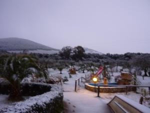 a snow covered park with people and a light at Agriturismo Isidoro in Fertilia