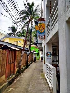 a street with a palm tree on the side of a building at 8 Colors Beach House Resort in Boracay