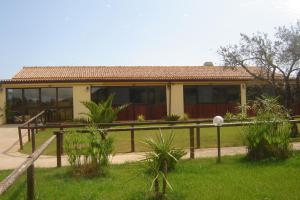 a house with a fence in front of it at Agriturismo Isidoro in Fertilia