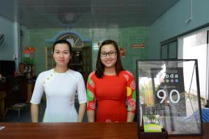 two women standing next to a table in a room at Diem Lien Guesthouse in Mui Ne