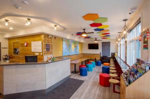 a fast food restaurant with a counter and chairs at Jasper Downtown Hostel in Jasper