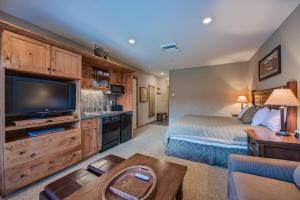 a living room filled with furniture and a tv at Silver Mountain Lodging in Kellogg
