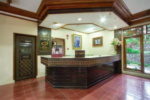 a large room with a bar in a building at Hotel Sahid Toraja in Makale