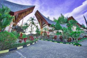 a building with a lot of flowers in front of it at Hotel Sahid Toraja in Makale
