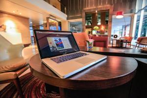 a laptop computer sitting on a table in a restaurant at Northgate Ratchayothin - SHA Extra Plus in Bangkok