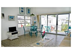 a living room with a table and chairs at Beauport One-Bedroom Apartment in Freeport
