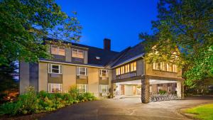 a large house with a driveway in front of it at Silver Fox Inn in Waterville Valley