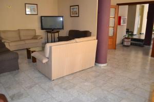 a living room filled with furniture and a tv at Hotel Don Manuel in Algeciras