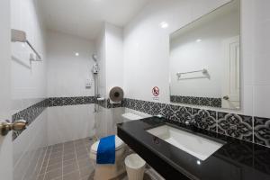 a bathroom with a sink and a toilet and a mirror at Vacation Time House in Nai Yang Beach