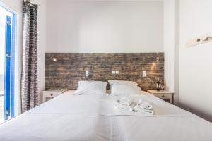Ein Bett oder Betten in einem Zimmer der Unterkunft Madaky Hotel