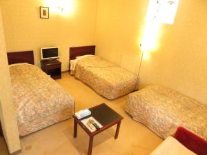 Postel nebo postele na pokoji v ubytování Nikko Pension L'escale