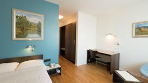 Postel nebo postele na pokoji v ubytování Hotel Terminus Brugg
