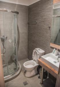 a bathroom with a shower and a toilet and a sink at Casa Christabella in Paralia Vrachou +45 photos