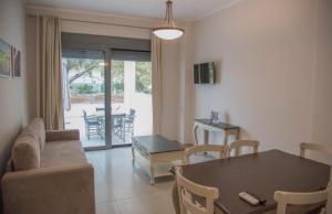 a living room with a couch and a table at Casa Christabella in Paralia Vrachou