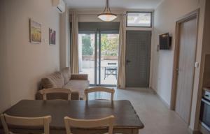 a living room with a table and a couch at Casa Christabella in Paralia Vrachou