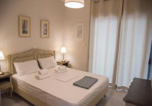 a bedroom with a bed with two towels on it at Casa Christabella in Paralia Vrachou