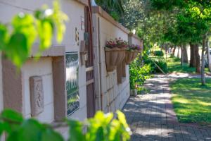 a building with potted plants on the side of it at Poetry Guestrooms in Vryburg