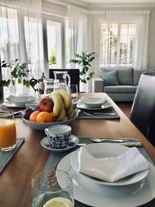 a dining room table with a bowl of fruit on it at Cashmere Hills B&B in Christchurch