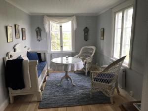 a living room with a table and chairs at Oxelbacka cottage in Enköping