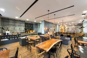 a restaurant with tables and chairs and a bar at Petit Palace Triball in Madrid
