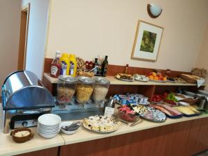 a buffet with many food items on a counter at Penzion Siesta in Valtice