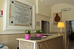 a restaurant with a counter with flowers on it at Sisters Hostel in Piano di Sorrento