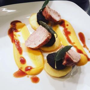 a plate of food with meat and fruit with sauce at The Kings Head Hotel in Ross on Wye