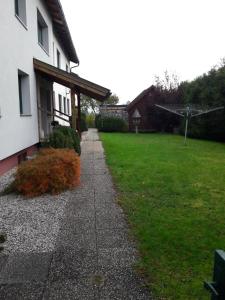 a sidewalk next to a house with a grass yard at Ferienhaus Steyrdurchbruch in Leonstein