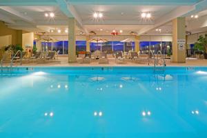 a pool in a hotel with chairs and tables at Red Lion Hotel Harrisburg Hershey in Harrisburg