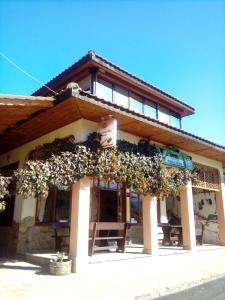 a building with flowers on the front of it at Guest House Ambrozia in Kotel +15 photos