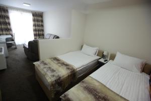 Postel nebo postele na pokoji v ubytování Garni Hotel Hollywoodland Wellness & Aquapark