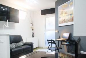 a living room with a table with a laptop on it at Holiday Home Arzilli in Follonica