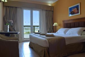 Postel nebo postele na pokoji v ubytování Ariti Grand Hotel
